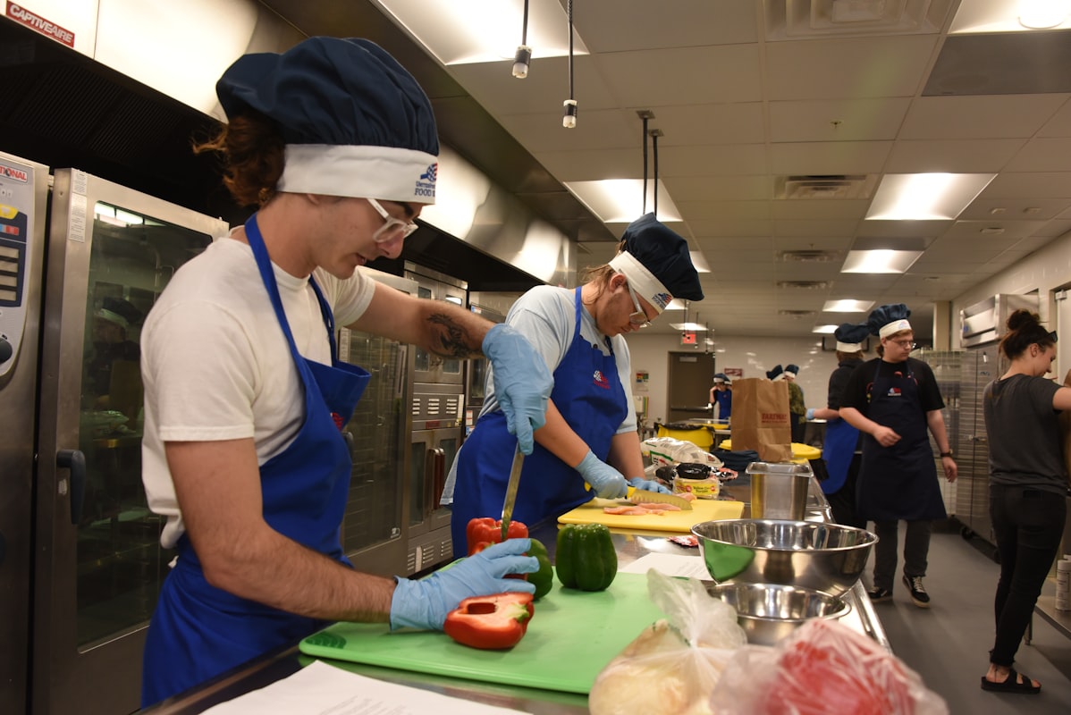 Professional culinary instructor preparing balanced meal in demonstration kitchen